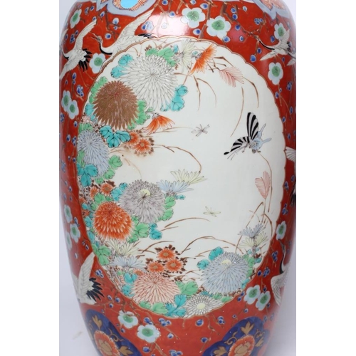 11 - A PAIR OF IMARI PORCELAIN VASES of rounded cylindrical form, painted in colours with insects in flig... 