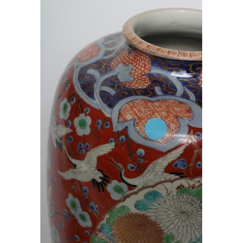 11 - A PAIR OF IMARI PORCELAIN VASES of rounded cylindrical form, painted in colours with insects in flig... 