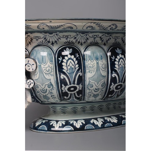 16 - A VILLEROY & BOCH FAIENCE CISTERN, late 19th century, of lobed oval form with two female mask lug ha... 