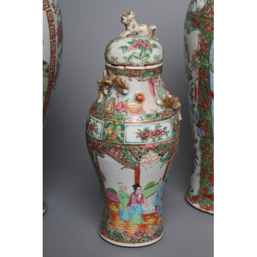 2 - THREE CANTONESE PORCELAIN FAMILLE ROSE VASES AND COVERS of inverted baluster form, all painted with ... 