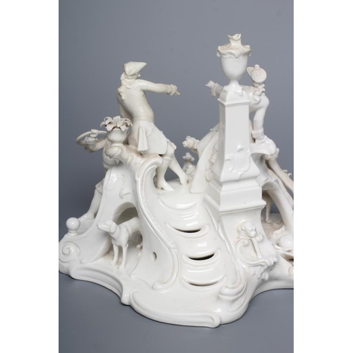 29 - A NYMPHENBURG BLANC-DE-CHINE PORCELAIN FIGURE GROUP, c.1900, modelled as a young couple in hunting a... 