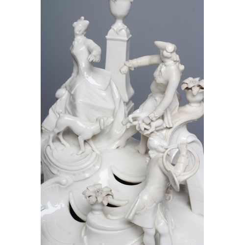 29 - A NYMPHENBURG BLANC-DE-CHINE PORCELAIN FIGURE GROUP, c.1900, modelled as a young couple in hunting a... 