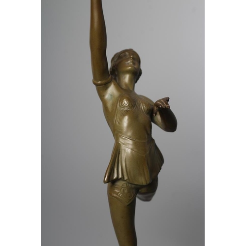 379 - AN ART DECO green patinated spelter figure in the style of Lorenzl, the young lady modelled standing... 