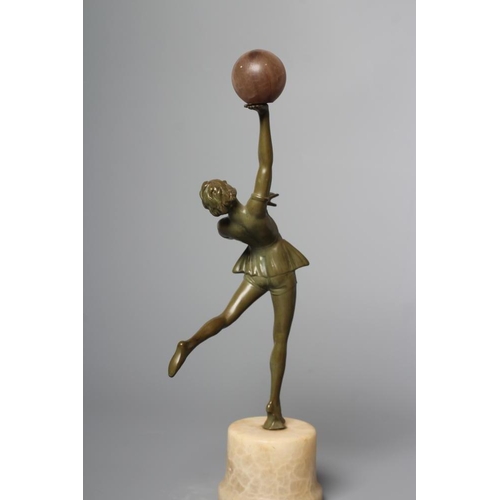 379 - AN ART DECO green patinated spelter figure in the style of Lorenzl, the young lady modelled standing... 