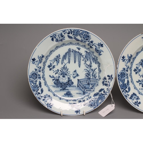 38 - A PAIR OF ENGLISH DELFT PLATES, probably Liverpool c.1760, painted in blue with a fence, weeping wil... 