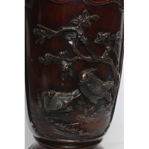 381 - A JAPANESE BRONZE VASE of cylindrical form with two dolphin handles, cast in relief with wading bird... 