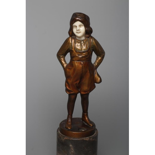 385 - B. GRUNDMANN - An Art Deco bronze figure cast as a young boy with carved ivory face wearing a cap on... 