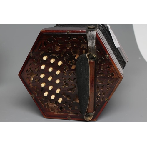 386 - A LACHENAL & CO. CONCERTINA of typical hexagonal form, with fret carved scroll design to both ends, ... 