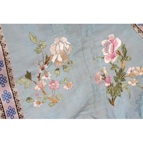 390 - A CHINESE SILK ROBE embroidered in coloured silks with flowers, the back centred by a roundel with a... 