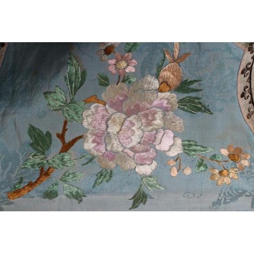 390 - A CHINESE SILK ROBE embroidered in coloured silks with flowers, the back centred by a roundel with a... 