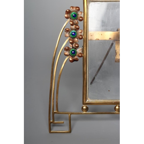 396 - A GERMAN JUGENDSTIL BRASS STRUT BACK PHOTOGRAPH FRAME, c.1900, the oblong glass plate with arched to... 