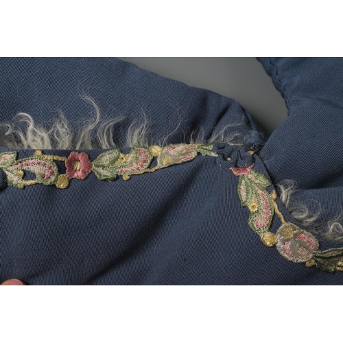 398 - A CHINESE WINTER ROBE, the plain blue woven coat with machine embroidered foliate braiding to all ed... 