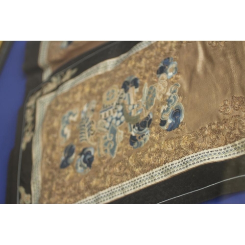 399 - A CHINESE PLEATED SKIRT with black silk satin gores, and blue embroidered foliate panels, with couch... 