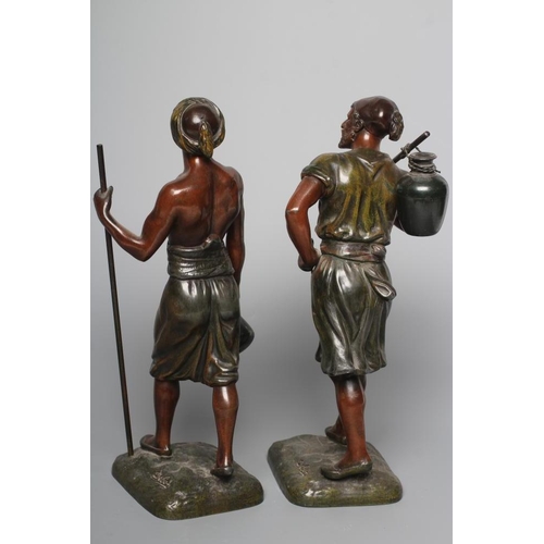 400 - A PAIR OF PAINTED SPELTER ARAB MALE WATER CARRIERS, after Marcel Debut (1865-1933) each modelled sta... 