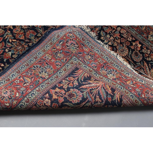 412 - A PERSIAN RUG, 20th century, the navy blue mirhab with vase and flowers, red and ivory floral corner... 