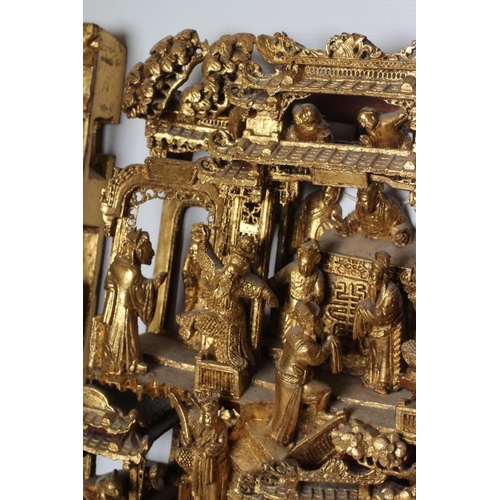 414 - A CHINESE CARVED AND PIERCED GILTWOOD PANEL, featuring a garden pavilion with noble figures flanked ... 