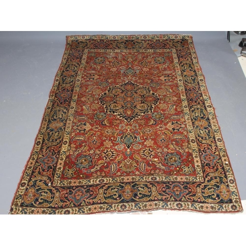 422 - A PERSIAN RUG, early 20th century, the red floral field with central navy blue gul, navy blue main b... 