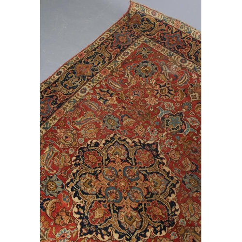 422 - A PERSIAN RUG, early 20th century, the red floral field with central navy blue gul, navy blue main b... 