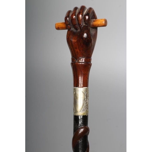 428 - TWO TWIST CARVED WALKING CANES, 19th century, comprising a hard wood stick carved with a British sol... 