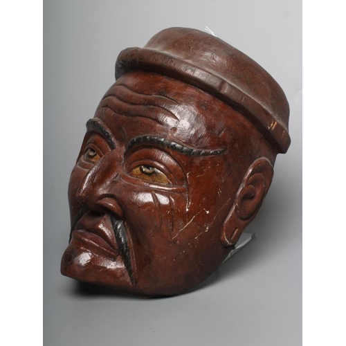 430 - A JAPANESE CARVED WOOD NOH MASK painted in red, black and white, with holes for the eyes and nostril... 