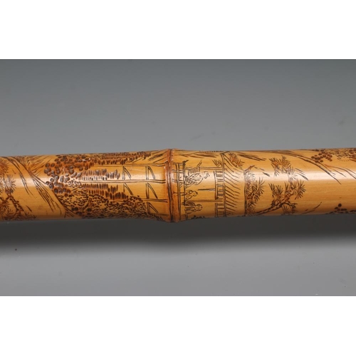 431 - A JAPANESE WALKING CANE, the bone grip carved in relief with a Samurai killing a tiger, bamboo shaft... 