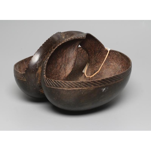 438 - A COCO DE MER carved as a double-welled basket, with etched rim and polished exterior, 10 1/4