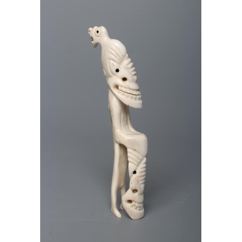 439 - A CARVED INUIT TOTEM, made of polar bear bone, from Kulusuk-Kap Dam, Greenland, with three faces and... 