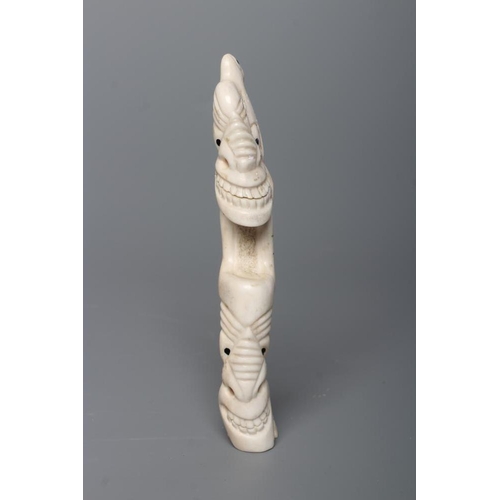 439 - A CARVED INUIT TOTEM, made of polar bear bone, from Kulusuk-Kap Dam, Greenland, with three faces and... 