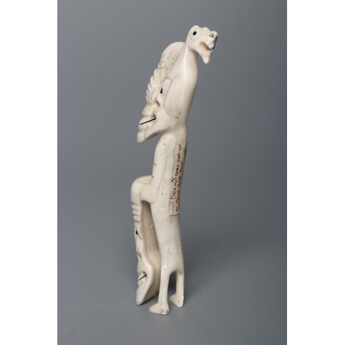 439 - A CARVED INUIT TOTEM, made of polar bear bone, from Kulusuk-Kap Dam, Greenland, with three faces and... 