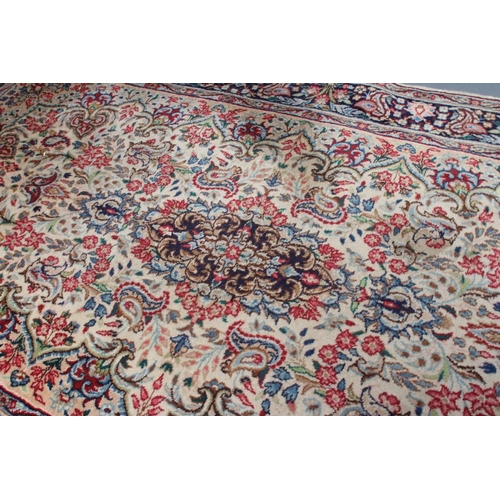 444 - A PERSIAN RUG, 20th century, the ivory and camel floral field centred by a navy blue gul all in shad... 