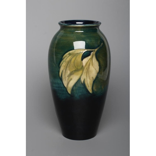 60 - A MOORCROFT POTTERY HIBISCUS PATTERN VASE, mid 20th century, of rounded cylindrical form, tubelined ... 