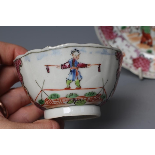 7 - A CHINESE PORCELAIN FAMILLE ROSE TEA BOWL AND SAUCER painted with a tightrope walker and a knife thr... 