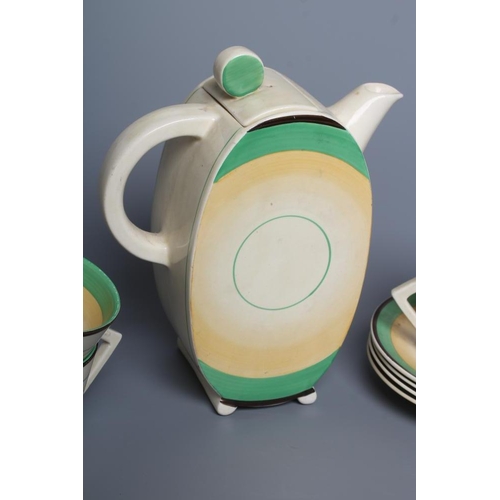 74 - AN ART DECO CLARICE CLIFF WILKINSON POTTERY BONJOUR PART COFFEE SERVICE, with green, yellow and blac... 