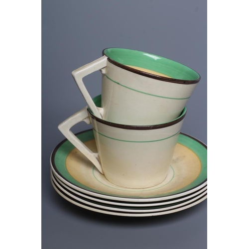 74 - AN ART DECO CLARICE CLIFF WILKINSON POTTERY BONJOUR PART COFFEE SERVICE, with green, yellow and blac... 