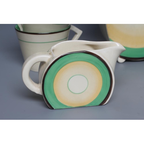 74 - AN ART DECO CLARICE CLIFF WILKINSON POTTERY BONJOUR PART COFFEE SERVICE, with green, yellow and blac... 