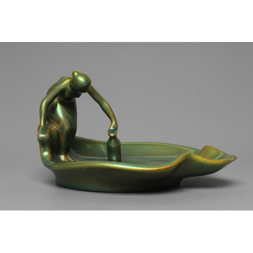 76 - A ZSOLNAY PECS GREEN IRIDESCENT POTTERY FIGURAL DISH, mid 20th century, modelled as a scantily drape... 