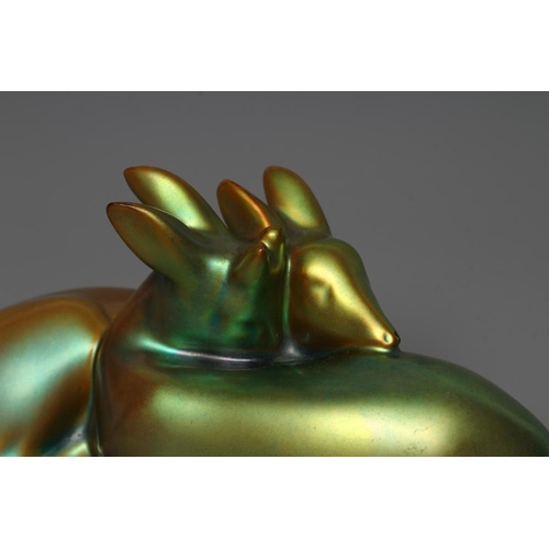 77 - A ZSOLNAY PECS GREEN IRIDESCENT POTTERY MODEL, mid 20th century, of two recumbent deer, printed gilt... 