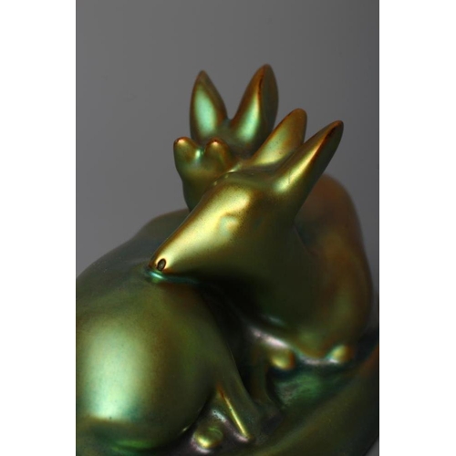 77 - A ZSOLNAY PECS GREEN IRIDESCENT POTTERY MODEL, mid 20th century, of two recumbent deer, printed gilt... 