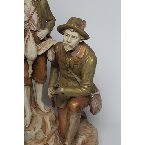 79 - A ROYAL DUX BISQUE PORCELAIN FIGURE GROUP, early 20th century, modelled as a father holding a double... 