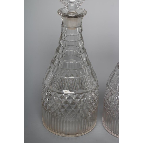 90 - A PAIR OF TRIPLE RING NECK MALLET GLASS DECANTERS, 19th century, with bullseye stoppers, the sloping... 