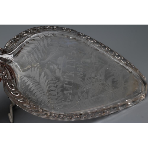 94 - A VICTORIAN ELIPTICAL GLASS FLASK with double spout and applied prunted edge, the fascia engraved 