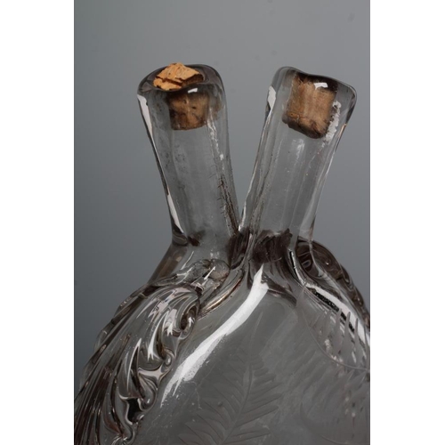 94 - A VICTORIAN ELIPTICAL GLASS FLASK with double spout and applied prunted edge, the fascia engraved 