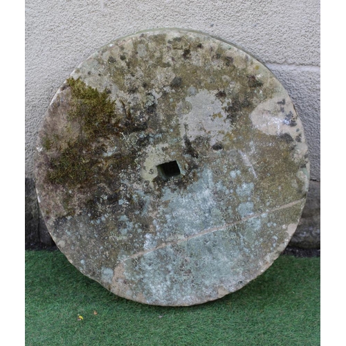 735 - A SANDSTONE GRINDING STONE, 25 1/2