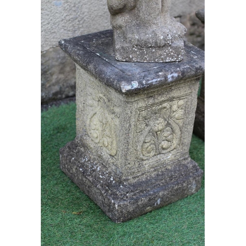 739 - A PAIR OF CAST STONE LIONS SEJANT, raised on associated flower moulded stepped square plinth, 12