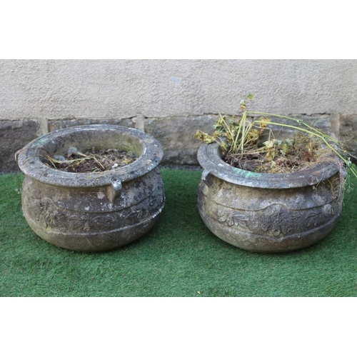 744 - A PAIR OF CAST STONE PLANTERS of cauldron form, the moulded rim with three handles over a band of fl... 