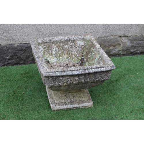 746 - A CAST STONE PLANTER of square form with moulded rim over a band of flower heads, raised on a steppe... 