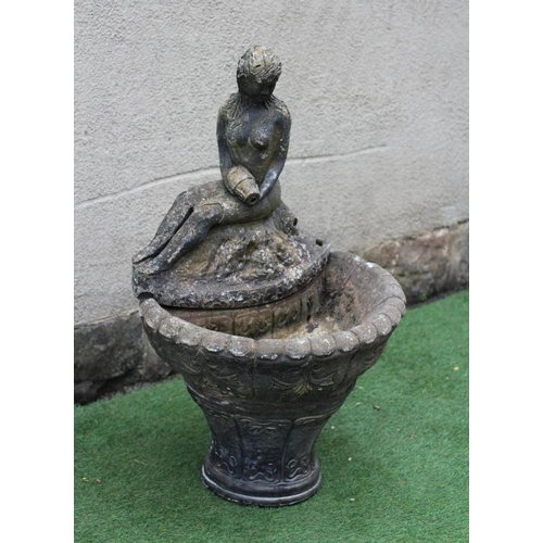 747 - A CAST STONE WATER FEATURE modelled as an escallop shell surmounted by a seated nymph with water ves... 