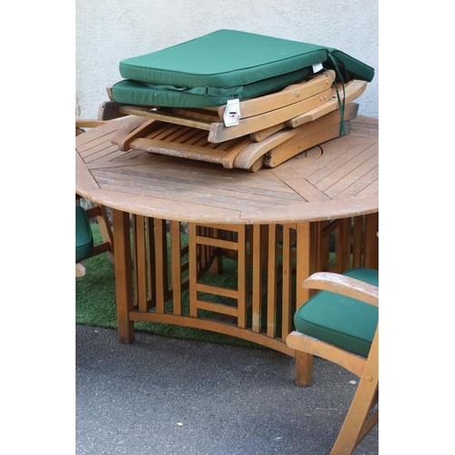 763 - AN ARTS & CRAFTS STYLE SLATTED TEAK DINING SUITE, the circular table on concave sided square base, 5... 