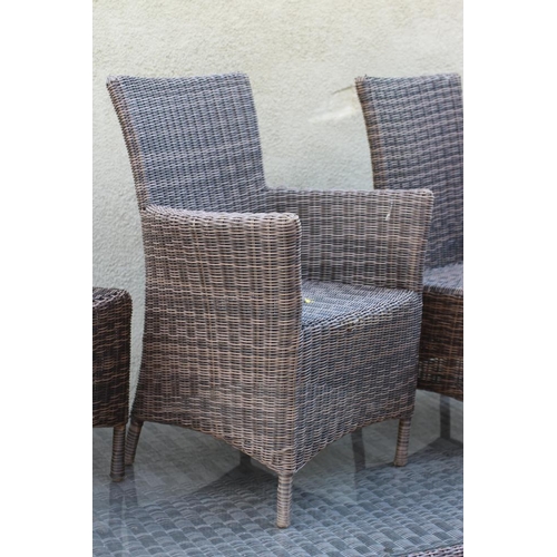 764 - AN ALL WEATHER RESIN WEAVE DINING SUITE, the oblong table with separate glass, raised on a pair of s... 