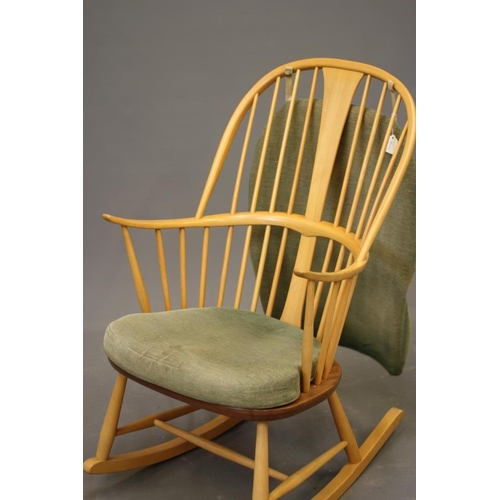 800 - AN ERCOL ROCKING CHAIR, mid 20th century, in blond beech and elm, the hooped spindle back centred by... 